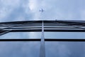 Airplane flying above modern architecture glass office building Royalty Free Stock Photo