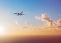 Airplane flying above ocean with sunset sky background - trav Royalty Free Stock Photo