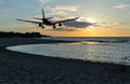 Airplane flying above the sea in sky with clouds Royalty Free Stock Photo