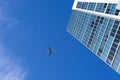 Airplane flying above a skyscraper Royalty Free Stock Photo
