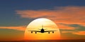 Airplane flying against the background of sunset