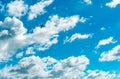 Airplane flying on beautiful blue sky and white cumulus clouds. Cloudscape background. Blue sky and fluffy clouds on sunny day. Royalty Free Stock Photo
