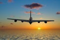 Airplane flying into a beautiful sunset Royalty Free Stock Photo