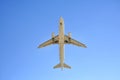 Airplane flying on blue sky background. Below view Royalty Free Stock Photo