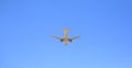 Airplane flying on blue sky background. Below view. Seen from rear and below Royalty Free Stock Photo