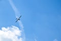 Airplane flying in the blue sky on background of white clouds, rear view. Twin-engine commercial plane during the turn, vacation Royalty Free Stock Photo