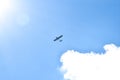 Airplane flying in the blue sky on background of white clouds, rear view. Twin-engine commercial plane during the turn, vacation Royalty Free Stock Photo