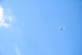 Airplane flying in the blue sky on background of white clouds, rear view. Twin-engine commercial plane during the turn, vacation Royalty Free Stock Photo