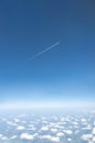 Airplane flying in the blue sky among clouds and sunlight Royalty Free Stock Photo