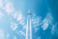 Airplane flying in a blue sky leaving a trail Royalty Free Stock Photo