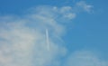 Airplane flying in the clear blue sky and contrail against, Engine exhaust contrails forming behind,  Jet contrails or trails over Royalty Free Stock Photo