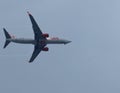 airplane flying in the cloudy sky