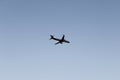 Airplane flying in dark blue evening sky. Plane on pure sky background