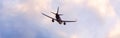 Airplane flying through an evening cloudscape panoramic view Royalty Free Stock Photo