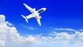 Airplane flying high in clear blue sunny sky above white clouds close up, passenger airliner departure, air flight, jet, plane Royalty Free Stock Photo