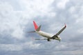 Airplane flying high in cloudy sky. Modern aircraft Royalty Free Stock Photo
