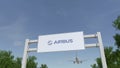 Airplane flying over advertising billboard with Airbus logo. Editorial 3D rendering