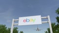 Airplane flying over advertising billboard with eBay Inc. logo. Editorial 3D rendering Royalty Free Stock Photo