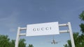 Airplane flying over advertising billboard with Gucci logo. Editorial 3D rendering