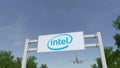 Airplane flying over advertising billboard with Intel Corporation logo. Editorial 3D rendering Royalty Free Stock Photo