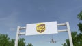 Airplane flying over advertising billboard with United Parcel Service UPS logo. Editorial 3D rendering Royalty Free Stock Photo