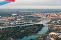 Airplane flying over Belgrade cityscape in Serbia Royalty Free Stock Photo