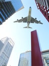 Airplane flying over city Royalty Free Stock Photo