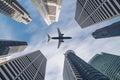 Airplane flying over city business buildings, high-rise skyscrapers Royalty Free Stock Photo