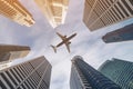 Airplane flying over city business buildings, high-rise skyscrapers Royalty Free Stock Photo