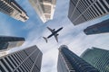 Airplane flying over city business buildings, high-rise skyscrapers Royalty Free Stock Photo