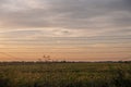 Airplane flying over a fence with barbed wire at sunset Royalty Free Stock Photo