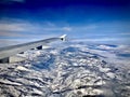 Airplane Flying Over Mountain Range Royalty Free Stock Photo