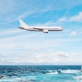 Airplane flying over ocean Royalty Free Stock Photo