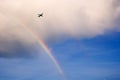 Airplane flying over rainbow Royalty Free Stock Photo