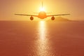 Airplane flying over the sea at sunset. Travel concept Royalty Free Stock Photo