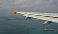 Airplane flying over the Singapore sea Royalty Free Stock Photo