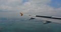 Airplane flying over the Singapore sea Royalty Free Stock Photo