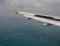 Airplane flying over the Singapore sea Royalty Free Stock Photo