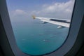 Airplane flying over the Singapore sea Royalty Free Stock Photo