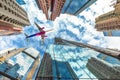 Airplane flying over skyscrapers Royalty Free Stock Photo