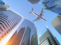 Airplane flying over skyscrapers n city downtown district. Business corporate travel background concept Royalty Free Stock Photo