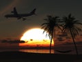 Airplane flying over tropical beach at sunset.