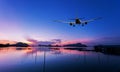 Airplane flying over tropical sea at beautiful sunset or sunrise Royalty Free Stock Photo