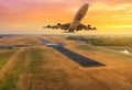 airplane flying take off from runway on sunset Royalty Free Stock Photo