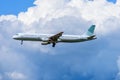 Airplane flying under the clouds Royalty Free Stock Photo