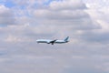 Airplane flying under the clouds Royalty Free Stock Photo