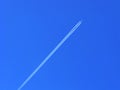 Airplane upwards and vapour trail on blue sky Royalty Free Stock Photo