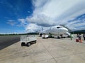 Airplane on The Apron Under Dramatical Clouds in The Sky Royalty Free Stock Photo