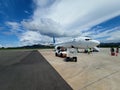 Airplane on The Apron Under Dramatical Clouds in The Sky Royalty Free Stock Photo