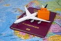 Airplane with a german passport on a world map Royalty Free Stock Photo